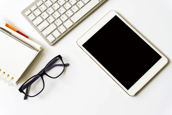 Office desk top view with smartphones, laptop eyeglasses and book.