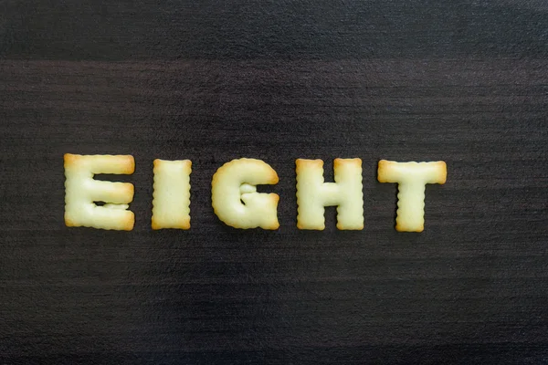 message written with letter biscuits, on wood background.