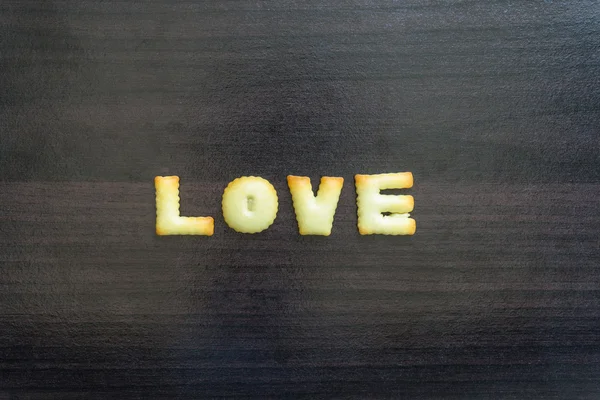 message written with letter biscuits, on wood background.