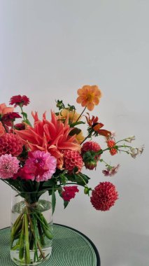 Portakal ve pembe çiçeklerden oluşan modern bir buket hediye, çeşitli şekil ve renklerde sonbahar çiçekleri. Çiçekçilik ve hediye konsepti, teslimat buketi.