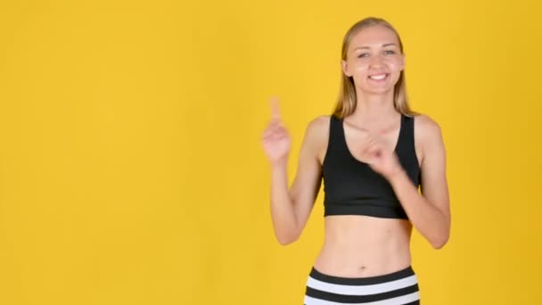 Young Friendy Blonde Girl Sportswear Smiles Shows Copy Space Empty — Stock Video