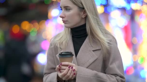 Chicas Rubias Jóvenes Con Una Taza Caliente Fondo Luces Festivas — Vídeo de stock