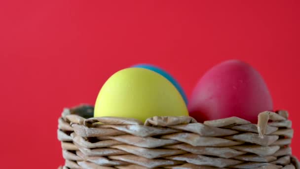 Easter Decoration Colorful Festive Eggs Lie Spinning Basket Red Background — Stock Video