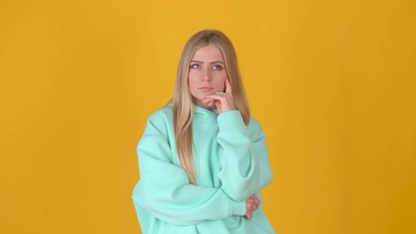 Young Blond Woman Thinking Something Standing Isolated Yellow Studio Background — Stock Video