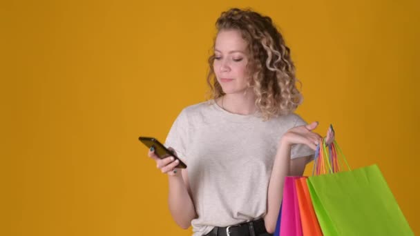 Young Happy Shopper Girl Curly Hair Holding Shopping Bags Uses — Stock Video