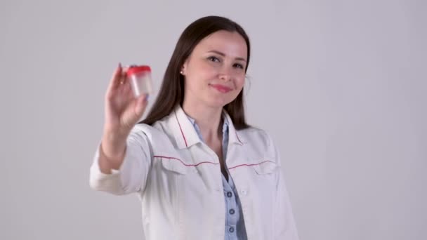 Portrait Female Doctor Medical Uniform Holding Test Container Points Finger — Stock Video