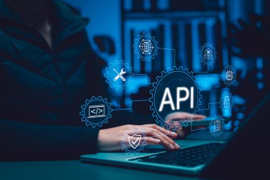 API Application Programming Interface concept. Person using laptop with digital gear icons, representing software integration, system connectivity, data exchange, automation, backend development tools