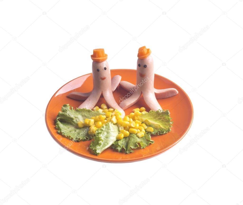 Sausages in the shape of octopus hats carrot on an orange plate 