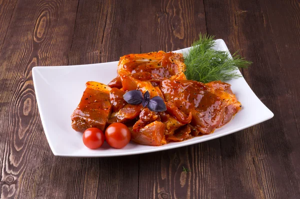 Pieces of raw pork on white plate — Stock Photo, Image