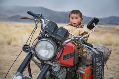 young nomad boy on motorbike clipart
