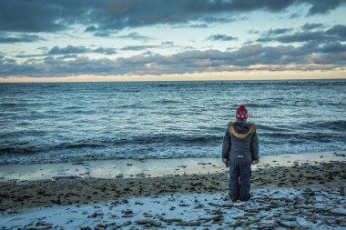 boy standing on Coast of Lake Peipus clipart