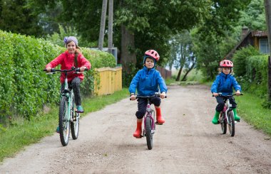  three children ride bikes clipart
