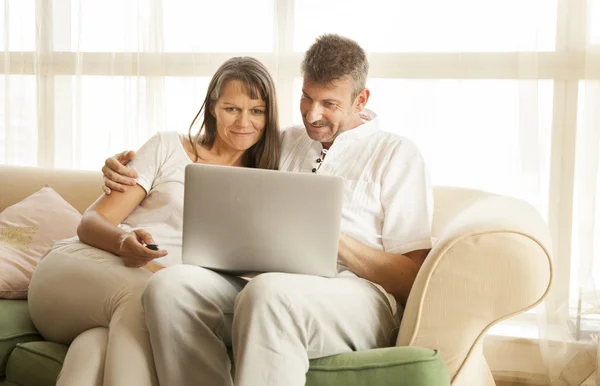middle aged couple with a computer