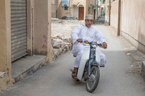 man ridding on bike in Nizwa