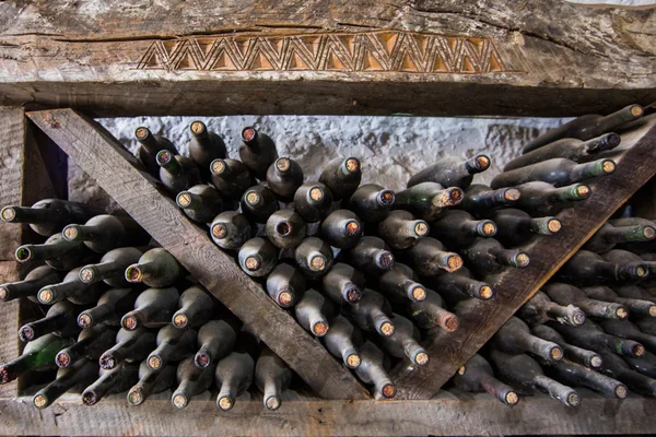 Garrafas de vinho velhas em uma adega — Fotografia de Stock