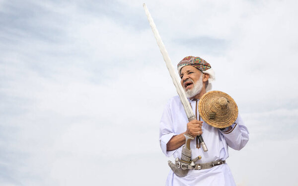 Ibri, Oman, 28th April 2018: men dancing and singing omani traditional way