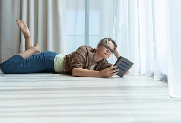 Vrouw Van Middelbare Leeftijd Die Thuis Leest — Stockfoto