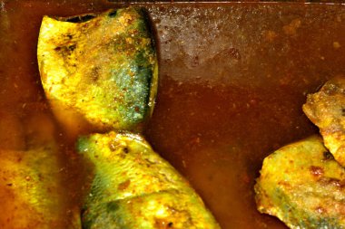 Geleneksel Bangladeş metodu olan tuzlu hilsa balığı hazırlama görüntüleri. Çiğ Hilsa dilimleri, balığı bakteriyel bozulmalardan ve böceklerden korumak için kullanılan tuz, zerdeçal ve biber tozuyla kaplıdır..