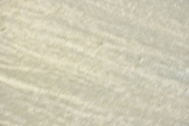 Rüzgâr ve sığ suların oluşturduğu doğal kum dalgalanmaları plaj yüzeyinde soyut desenler oluşturur. Tasarım ve doğa kavramları için ideal minimum kıyı arkaplanı, ince ışık ve organik kumlu detaylar.