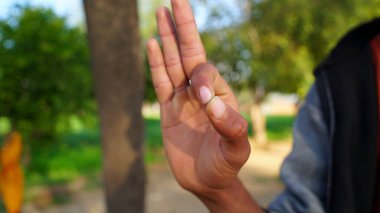 Making thumbs up gesture and showing ok sign. Sign expressing positiveness, thoughtful and well done.
