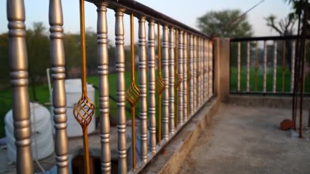 Silver and golden iron railing on the rooftop. Slow motion footage of stainless steel fence fore home interior decoration. — Stock Video