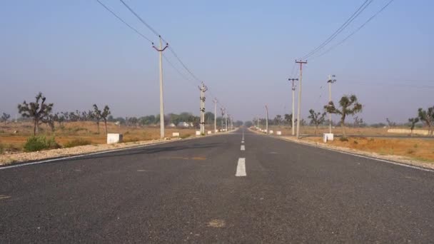 Indian transportation concept. Express road through empty field in countryside India. — Stock Video