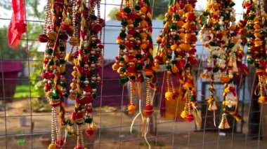 Kırmızı ve turuncu renkli kapı süslemesi için yapay çiçek çelengi veya Toran Latkan. Demirden çitlere asılı ana kapı duvarı..