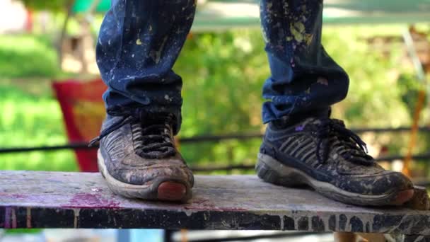 An Indian feet of painter. Shoes with color drops on a ladder. Indian painter feet closeup. — Stock Video