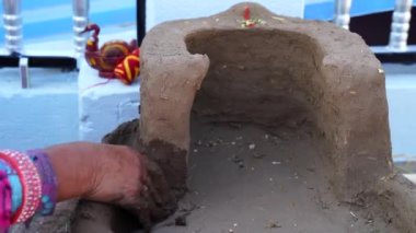 Çamur sobası. Kil sobayı biçimlendirmek için geleneksel el yapımı sanat. Kırsal Hindistan 'da kil ocağı yapmak antik bir sanattır..