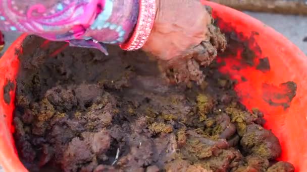 Mezclar a mano arcilla y estiércol de vaca mortero en bañera. Arte antiguo para la formación de la cocina de cerámica de arcilla. — Vídeo de stock