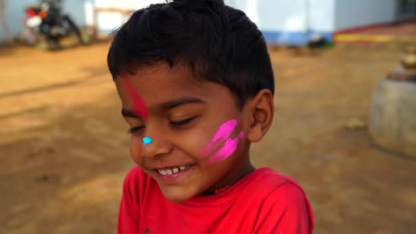 Filmagem 4K de crianças indianas a salpicar Gulal orgânico ou Abhir uns aos outros. Crianças rosto cobrindo com a tintura de cor diferente na Índia. — Vídeo de Stock
