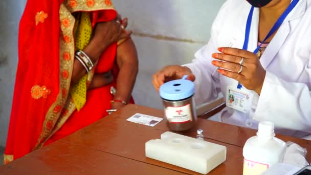 Health worker cutting and disinfecting needle in plastic cutter with a plastic cutter machine. — Stock Video