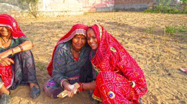 15 Nisan 2021 - Reengus, Sikar, Hindistan. İki Hindu kültürlü kadın birbirine sarılıyor. Neşeli gülen yüzlü yaşlı bir kadın..