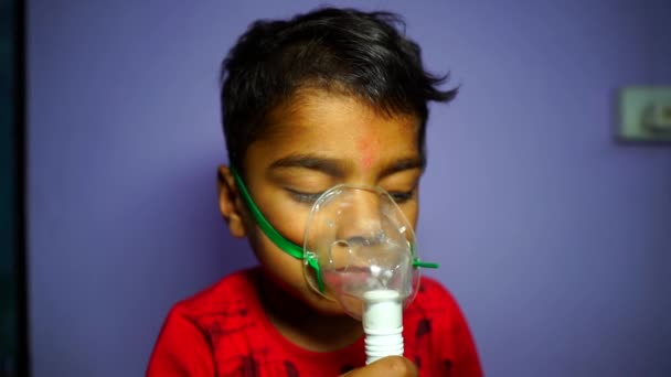 Slow motion footage,  Sick cute Asian child making inhalation with medical ultrasonic inhaler in domestic room. — Vídeo de stock
