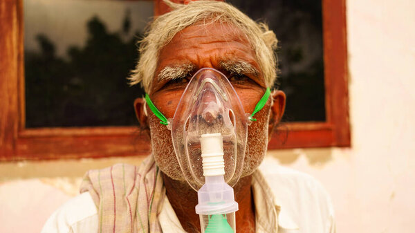 Selective focus on Oxygen mask or inhalation Cannula with liquid Oxygen supply. Liquid breathing mask closeup shot view.