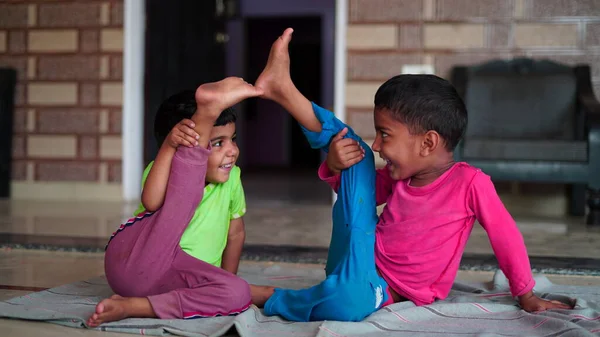 Worldwide yoga day concept. Indian little children laughing and joking along with yoga.