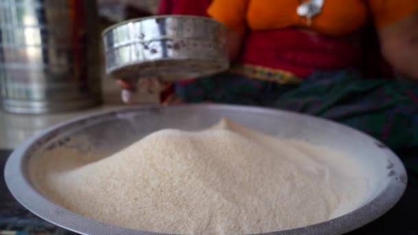 Chef sifts flour through a sieve on a wooden table. Traditional way to sift wheat flour. — Stock Video