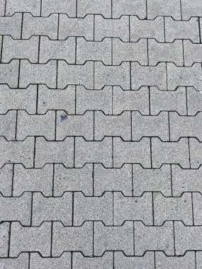 Durable interlocking gray concrete paving stones forming a textured walkway pattern surface