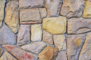 Değişik şekillere ve toprak tonlarına sahip doğal taş duvar dokusu, arka plan için mükemmel.