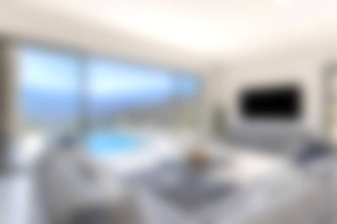 Geniş pencerelerin arasından çarpıcı bir okyanus manzarası olan modern bir oturma odası, konfor ve lüksü parlak doğal ışık ve minimalist dekorla harmanlıyor..