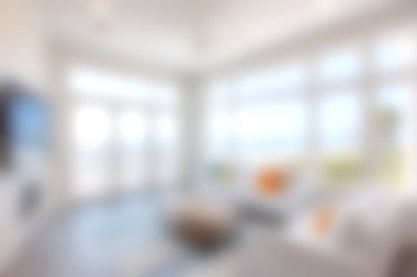 Parlak ve davetkar oturma odası geniş pencereli rahat bir tasarım sergiliyor, çarpıcı sahil manzarası ve rahatlamak için mükemmel bir modern ortam sunuyor..