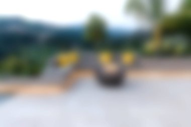 Canlı yeşillik ve manzaralı manzarayla çevrili rahat bir sandalyeye sahip sakin bir veranda. Rahatlama ve boş zaman aktiviteleri için ideal.