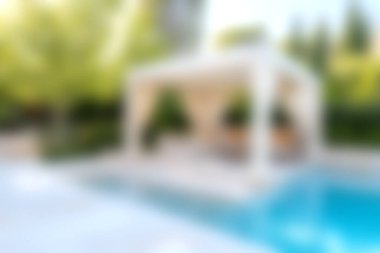 Parlak bir yüzme havuzunun yanında, yemyeşil çerçeveli güzel bir balkon. Bu huzurlu ortam güneşli günlerde rahatlamaya ve keyif almaya davet eder..