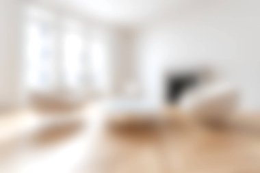 Hafif minimalist oturma odasında ahşap zeminde yumuşak mobilyalar var. Huzurlu ve davetkar bir atmosfer yaratıyor. Rahatlamak ya da eğlenmek için mükemmel..