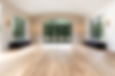 Geniş pencereleri ve parlak ahşap döşemeleri olan modern boş bir oda. İç tasarım fikirlerini sergilemek için mükemmel. Parlak ve davetkar bir ortam ve sakin bir ortam..