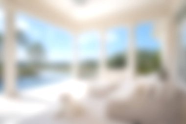 Açık hava manzarasını çerçeveleyen geniş pencereli parlak ve havadar bir oturma odası dinlenmek için sakin ve davetkar bir atmosfer yaratıyor..