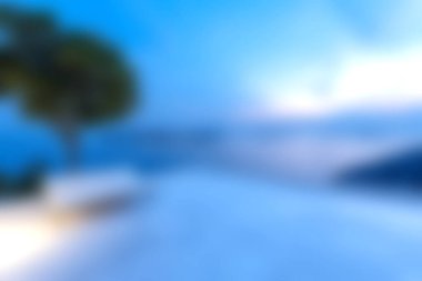 Alacakaranlıkta sakin bir sahil manzarası, yumuşak bir deniz ve bir ağaç silueti. Yumuşak mavi renkler rahatlatıcı bir ortam yaratır, rahatlama ve huzur için mükemmeldir..