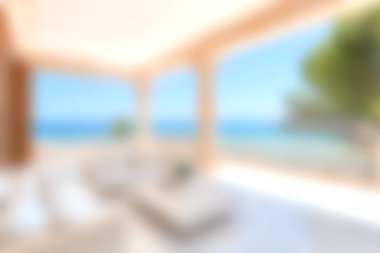 Muhteşem bir okyanus manzarası sunan geniş pencereli sakin bir oturma odası. Modern dekor ve doğal ışık davetkar ve rahatlatıcı bir atmosfer yaratır..