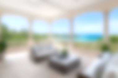 Geniş pencereli, parlak ve modern dinlenme odası büyüleyici okyanus manzarası ve yemyeşil, rahatlama ve rahatlama için mükemmel..