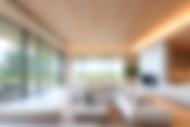 Bu resim, büyük pencerelerden doğal ışığı maksimuma çıkaran, samimi ve davetkar bir atmosfer yaratan minimalist dekorlu modern bir oturma odasını içeriyor..